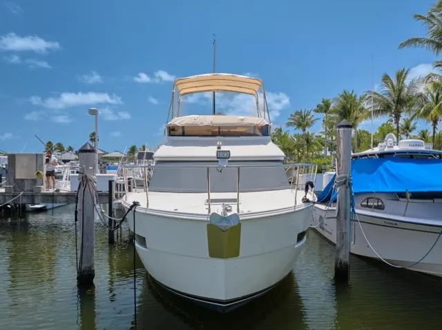 Yacht Photos Pics 2015 Carver C34 Command Bridge yacht docked at marina under clear blue sky.