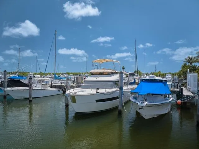  Yacht Photos Pics 2015 Carver C34 Command Bridge yacht docked in a sunny marina.