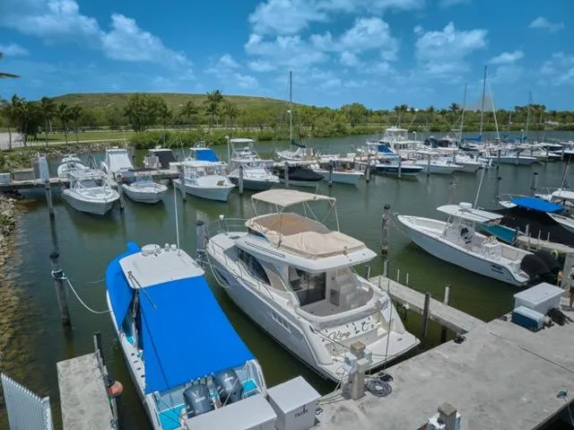  Yacht Photos Pics 2015 Carver C34 Command Bridge yacht docked in a scenic marina under a blue sky.