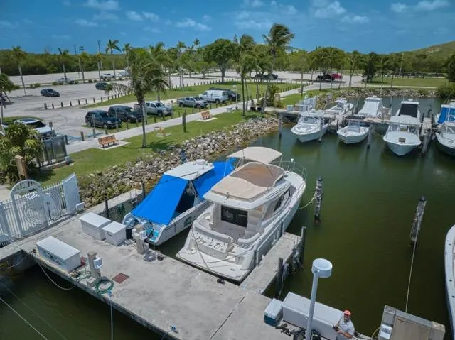  Yacht Photos Pics 2015 Carver C34 Command Bridge docked at a marina under a clear blue sky.