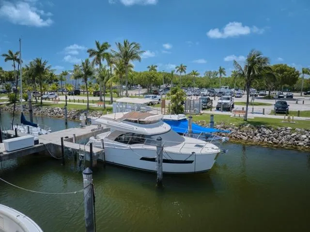  Yacht Photos Pics 2015 Carver C34 Command Bridge yacht docked at a marina with palm trees.