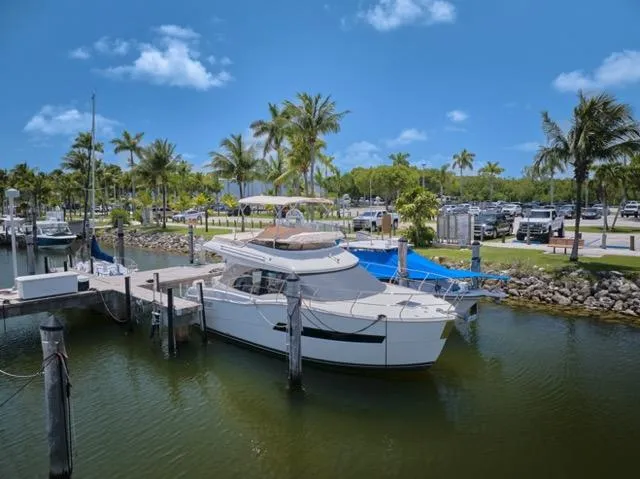  Yacht Photos Pics 2015 Carver C34 Command Bridge yacht docked in a tropical marina setting.