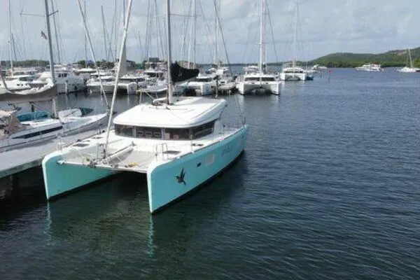 Zun Zun Yacht Photos Pics 2014 Lagoon 39 catamaran docked in a marina, surrounded by other boats.