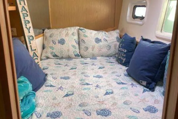 Zun Zun Yacht Photos Pics Cozy cabin interior of 2014 Lagoon 39 with nautical-themed bedding and pillows.