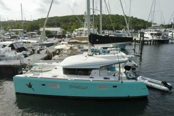 Zun Zun Yacht Photos Pics 2014 Lagoon 39 catamaran docked at marina, turquoise hull, surrounded by other boats.
