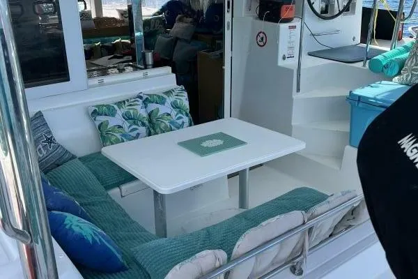 Zun Zun Yacht Photos Pics Cozy seating area on 2014 Lagoon 39 catamaran with cushions and table.
