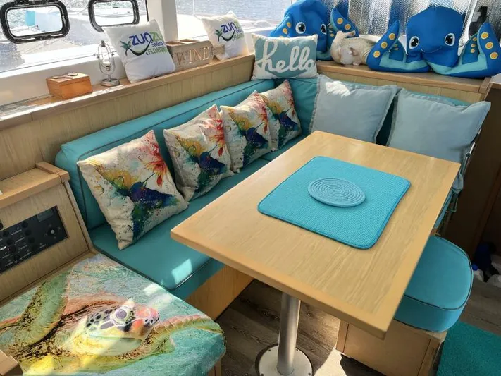 Zun Zun Yacht Photos Pics Cozy interior of 2014 Lagoon 39 catamaran with colorful cushions and nautical decor.