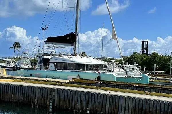 Zun Zun Yacht Photos Pics 2014 Lagoon 39 catamaran docked at marina under blue sky.