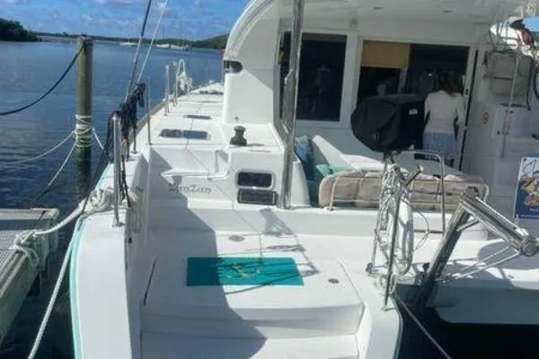 Zun Zun Yacht Photos Pics 2014 Lagoon 39 catamaran docked, featuring spacious deck and seating area under clear skies.