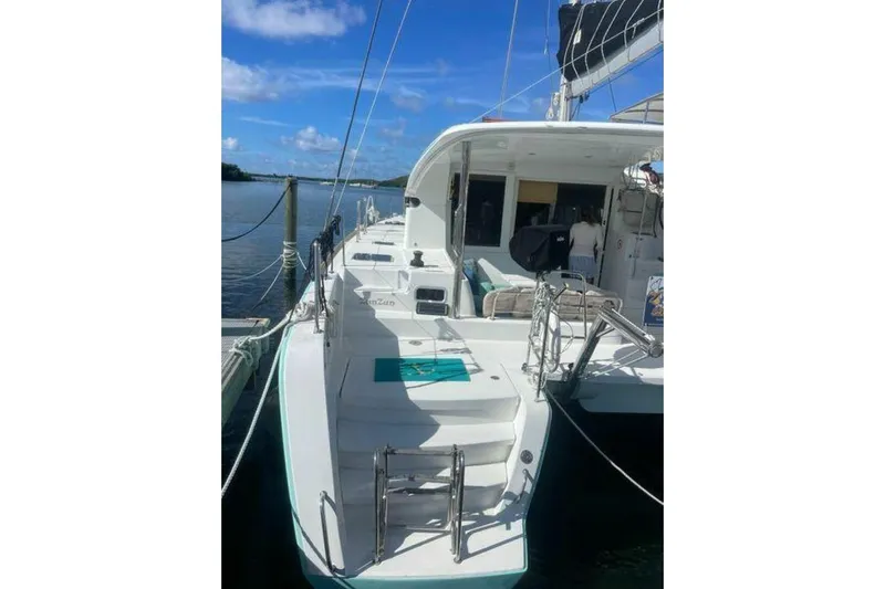 Zun Zun Yacht Photos Pics 2014 Lagoon 39 catamaran docked, featuring spacious deck and clear blue skies.