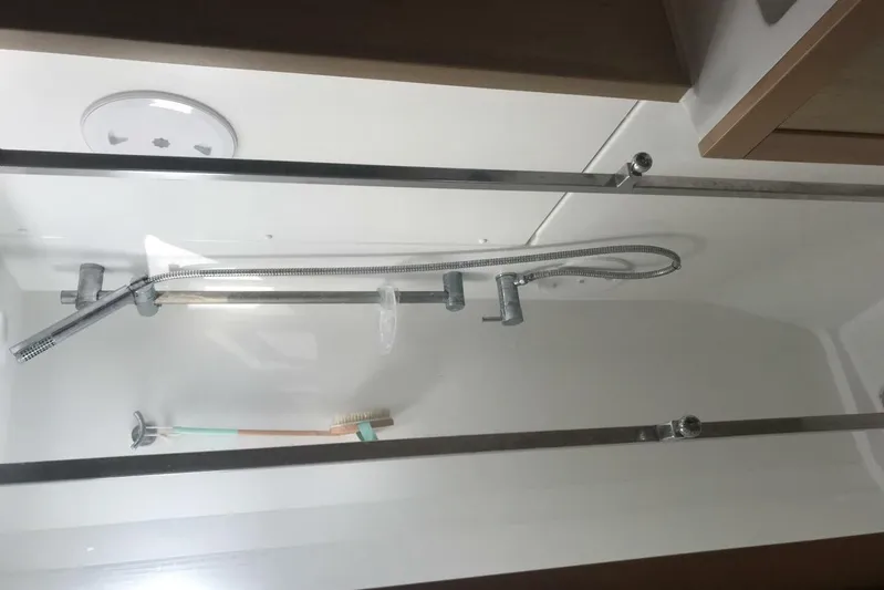 Zun Zun Yacht Photos Pics Shower area inside 2014 Lagoon 39 catamaran, featuring modern fixtures and toothbrush.