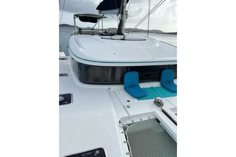 Zun Zun Yacht Photos Pics 2014 Lagoon 39 catamaran deck with blue seating, sailing on calm waters.