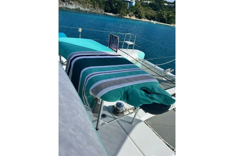 Zun Zun Yacht Photos Pics 2014 Lagoon 39 catamaran with striped towels, anchored in a scenic bay.