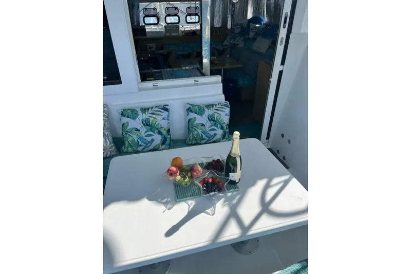 Zun Zun Yacht Photos Pics Outdoor dining area on 2014 Lagoon 39 yacht with fruit and champagne.
