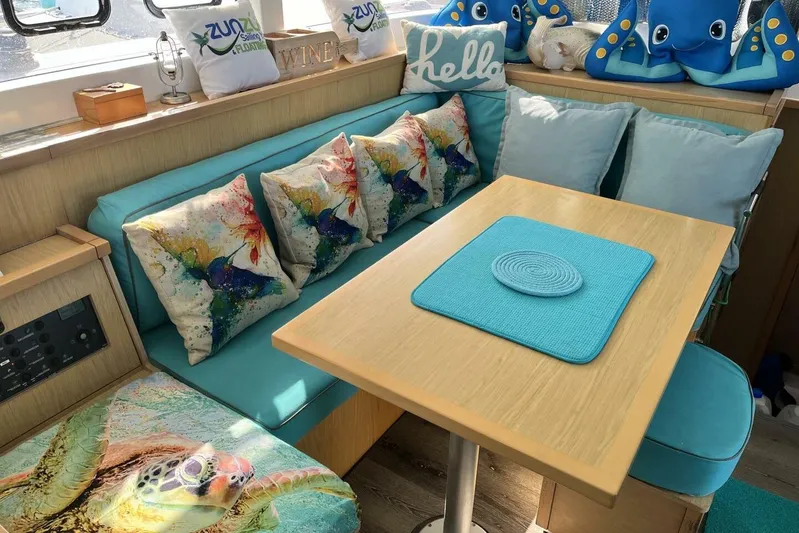 Zun Zun Yacht Photos Pics Cozy interior of 2014 Lagoon 39 catamaran with colorful cushions and nautical decor.