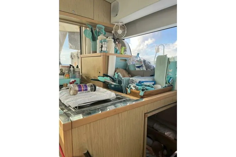 Zun Zun Yacht Photos Pics Interior of a 2014 Lagoon 39 catamaran with kitchen utensils and supplies.