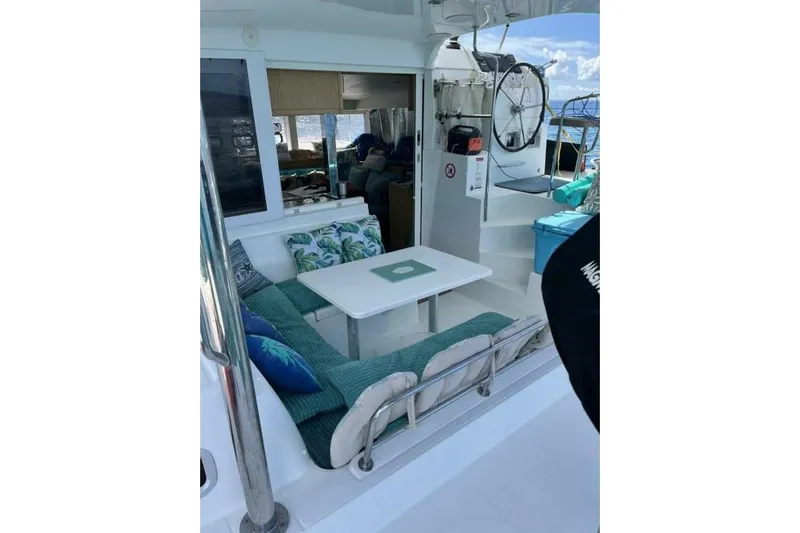 Zun Zun Yacht Photos Pics Cozy seating area on a 2014 Lagoon 39 catamaran with cushions and table.