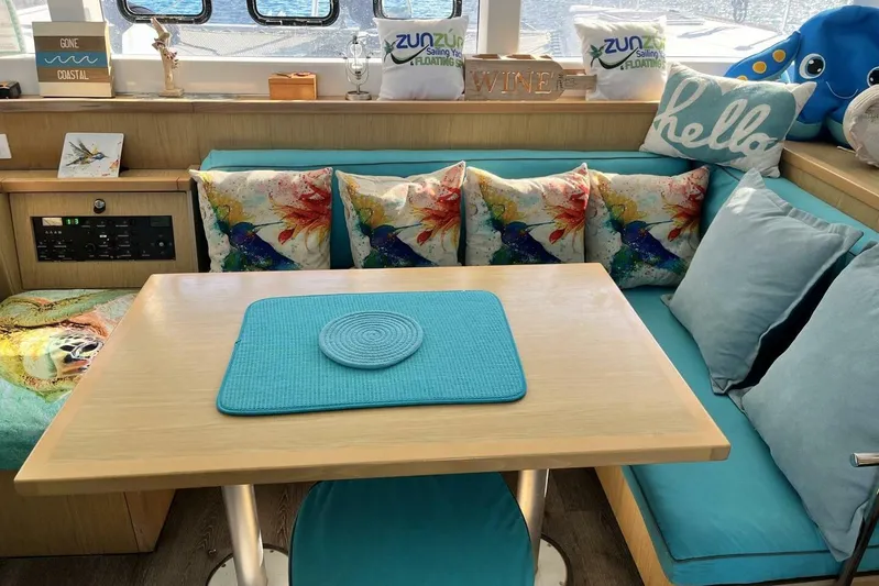 Zun Zun Yacht Photos Pics Cozy interior of 2014 Lagoon 39 catamaran with colorful cushions and nautical decor.