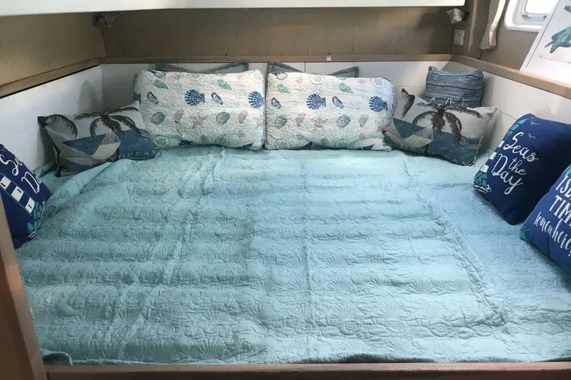 Zun Zun Yacht Photos Pics Cozy bedroom in 2014 Lagoon 39 catamaran with nautical-themed pillows and bedding.