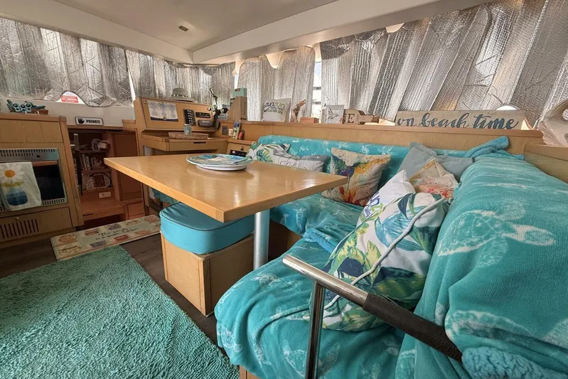 Zun Zun Yacht Photos Pics Cozy interior of 2014 Lagoon 39 catamaran with turquoise decor and dining area.