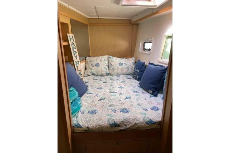 Zun Zun Yacht Photos Pics Cozy cabin interior of 2014 Lagoon 39 catamaran with nautical-themed bedding.