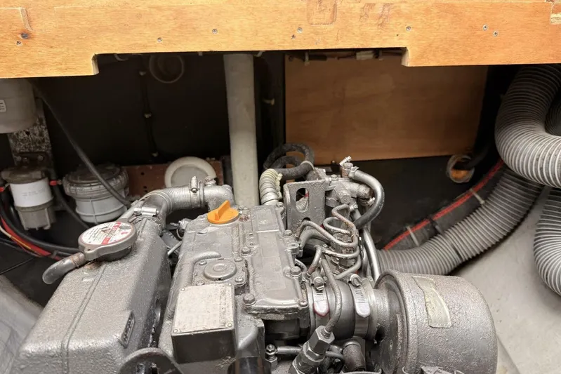 Zun Zun Yacht Photos Pics Engine compartment of a 2014 Lagoon 39 catamaran, showcasing mechanical components and hoses.