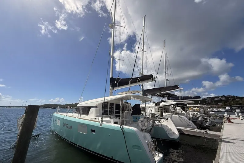 Zun Zun Yacht Photos Pics 2014 Lagoon 39 catamaran docked under a bright blue sky.