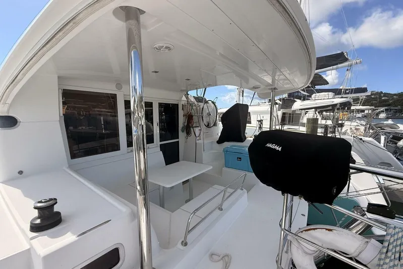 Zun Zun Yacht Photos Pics 2014 Lagoon 39 catamaran deck with seating area and covered equipment.