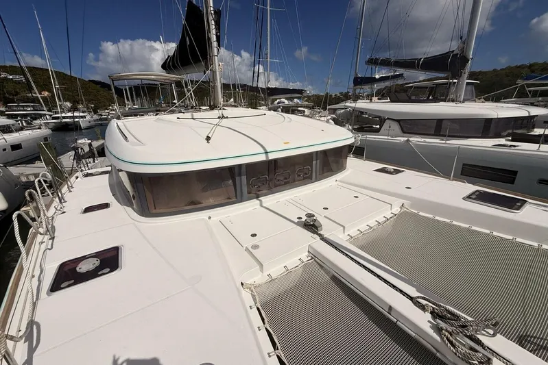 Zun Zun Yacht Photos Pics 2014 Lagoon 39 catamaran docked at marina, featuring spacious deck and netting.