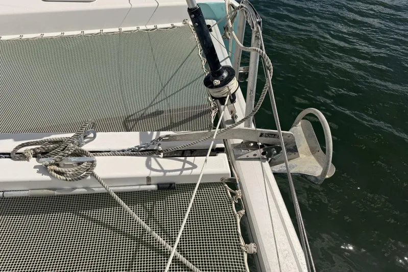 Zun Zun Yacht Photos Pics 2014 Lagoon 39 catamaran anchor and netting detail on calm water.
