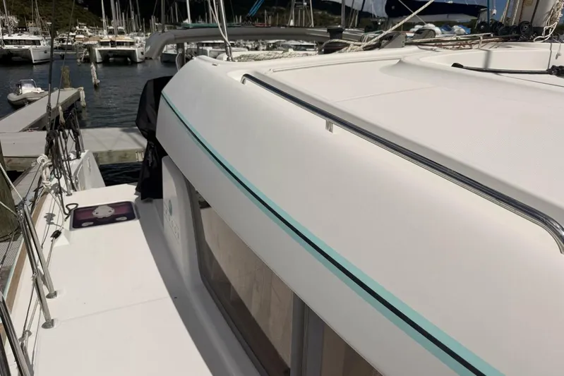 Zun Zun Yacht Photos Pics 2014 Lagoon 39 catamaran docked at marina, showcasing sleek design and spacious deck.