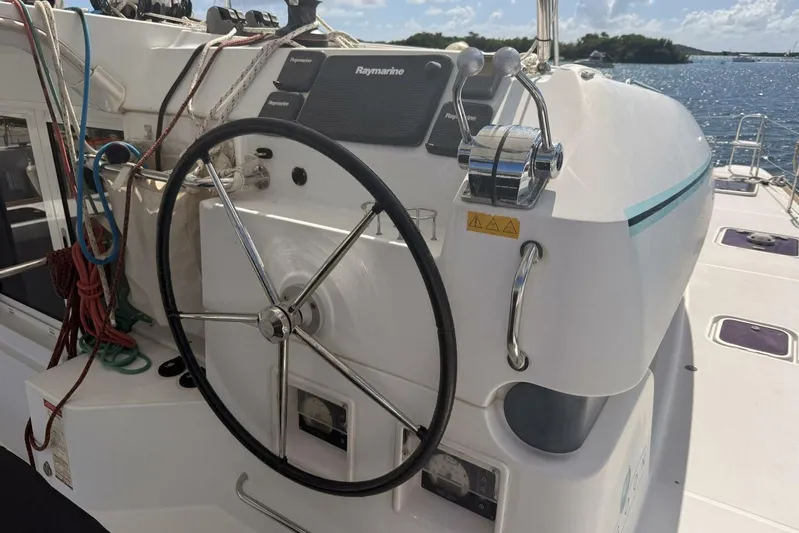 Zun Zun Yacht Photos Pics Steering wheel and controls of a 2014 Lagoon 39 catamaran, with ocean view.