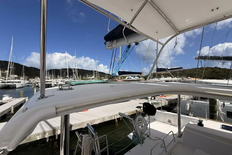 Zun Zun Yacht Photos Pics 2014 Lagoon 39 catamaran docked at marina, clear sky, sailboats in background.
