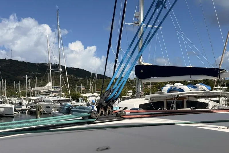 Zun Zun Yacht Photos Pics 2014 Lagoon 39 catamaran docked in a marina with clear skies.