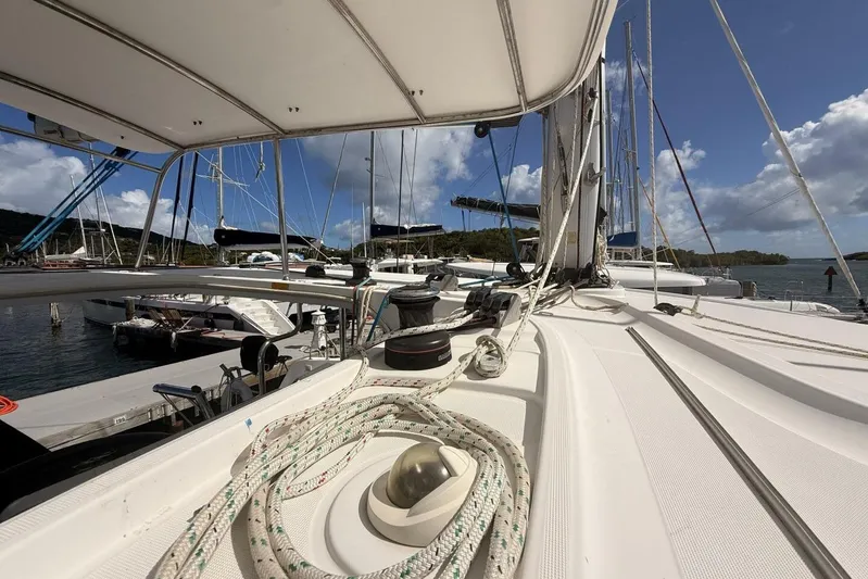 Zun Zun Yacht Photos Pics 2014 Lagoon 39 catamaran docked at marina under clear blue sky.
