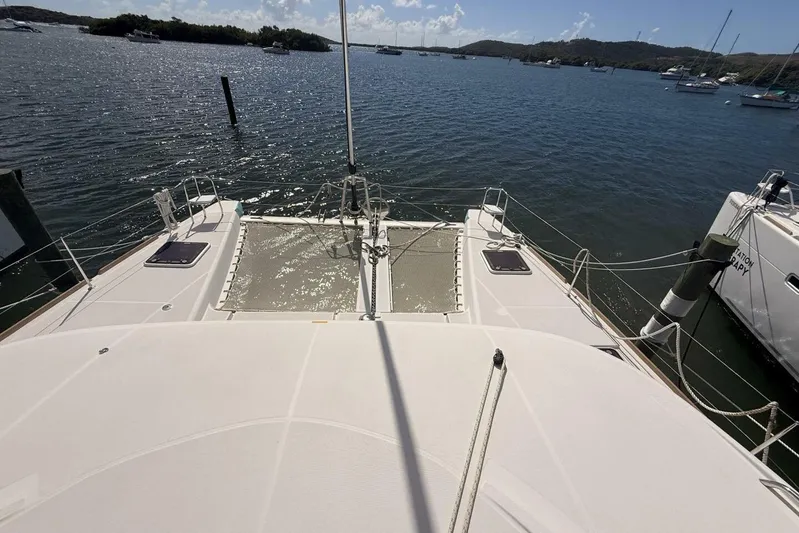 Zun Zun Yacht Photos Pics 2014 Lagoon 39 catamaran docked in a scenic marina, sunny day.
