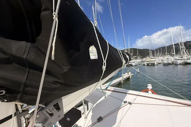 Zun Zun Yacht Photos Pics 2014 Lagoon 39 sailboat docked in a marina, featuring a covered sail and clear skies.