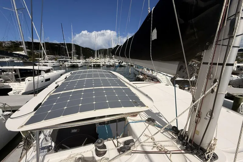Zun Zun Yacht Photos Pics 2014 Lagoon 39 catamaran with solar panels docked in a marina under clear blue skies.