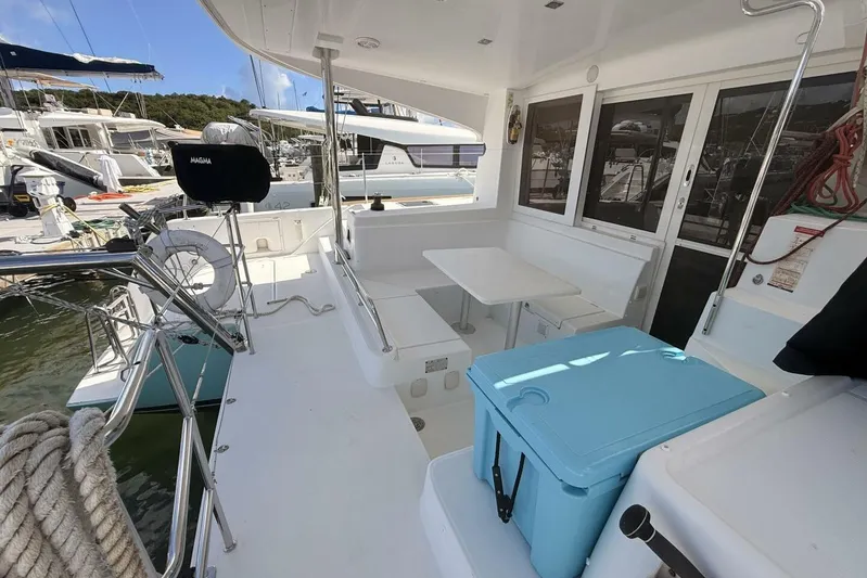 Zun Zun Yacht Photos Pics 2014 Lagoon 39 catamaran deck with seating, table, and storage, docked at marina.