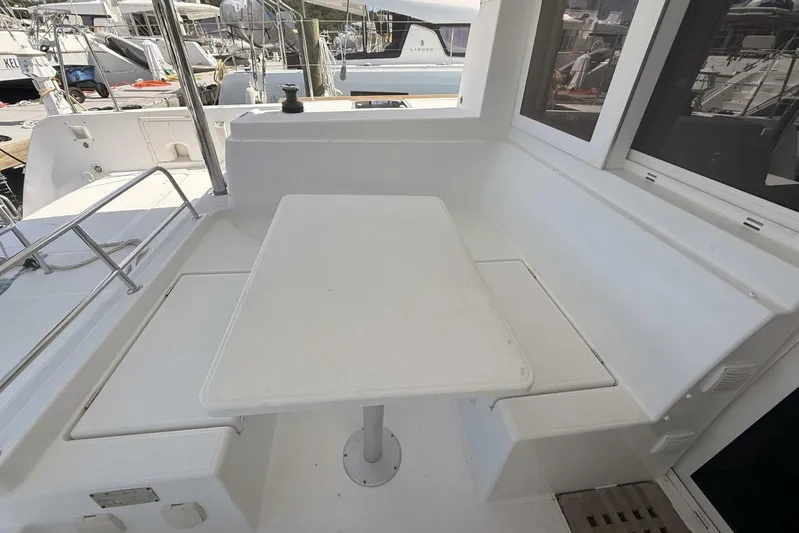 Zun Zun Yacht Photos Pics Outdoor seating area on a 2014 Lagoon 39 catamaran, featuring a white table and benches.