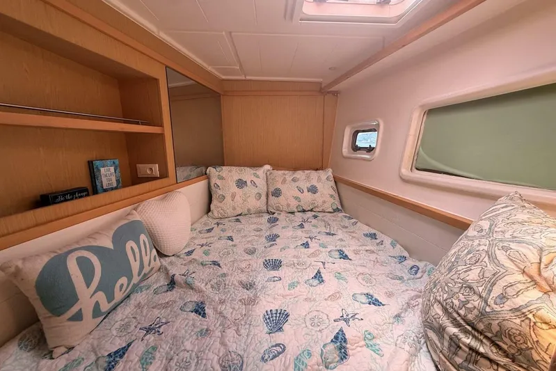 Zun Zun Yacht Photos Pics Cozy cabin interior of 2014 Lagoon 39 catamaran with nautical-themed bedding.