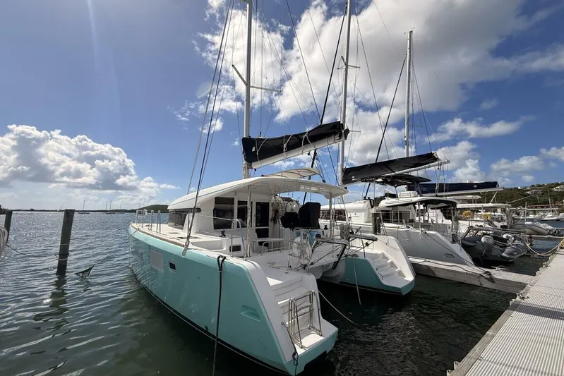 Zun Zun Yacht Photos Pics 2014 Lagoon 39 catamaran docked at marina under blue sky.