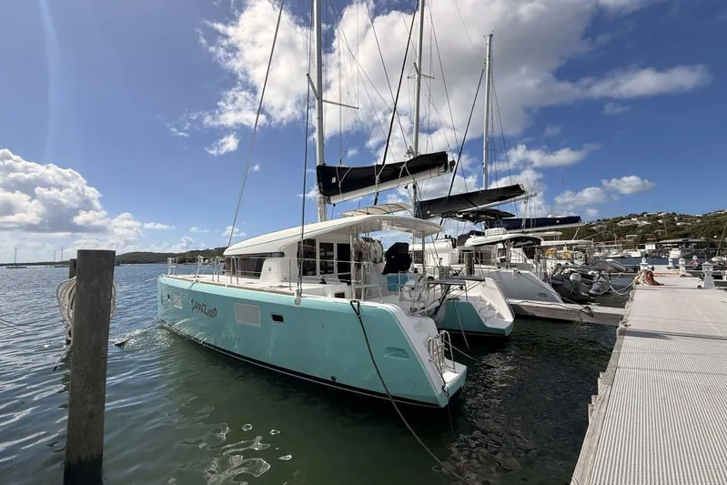 Zun Zun Yacht Photos Pics 2014 Lagoon 39 catamaran docked at marina under blue sky.