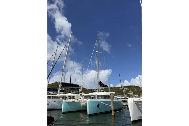 Zun Zun Yacht Photos Pics 2014 Lagoon 39 catamaran docked in a marina under a clear blue sky.
