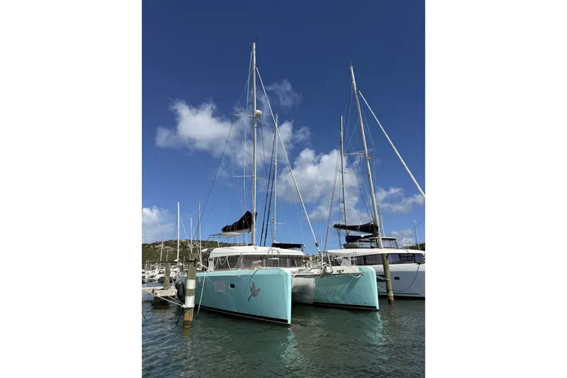 Zun Zun Yacht Photos Pics 2014 Lagoon 39 catamaran docked in a marina under a clear blue sky.
