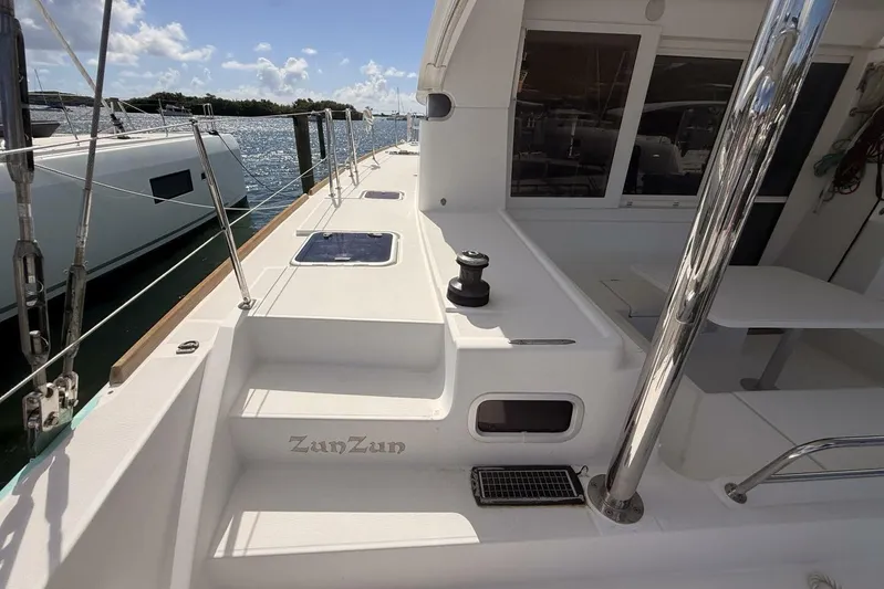 Zun Zun Yacht Photos Pics 2014 Lagoon 39 catamaran deck with winch, docked by the water.