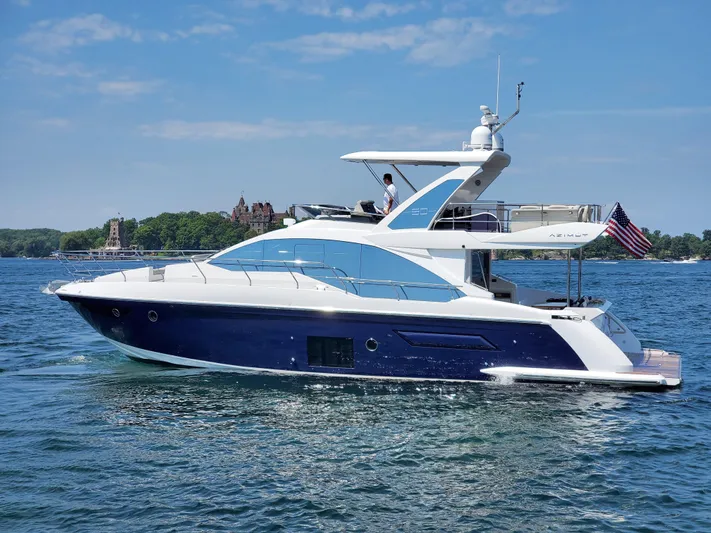  Yacht Photos Pics 2018 Azimut 50 Flybridge yacht on a serene lake with clear skies.
