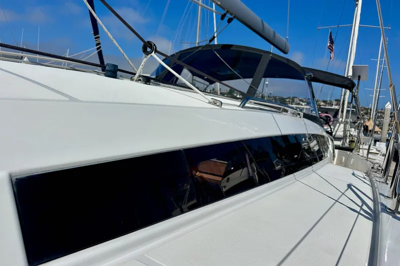 Best Day Ever Yacht Photos Pics Jeanneau Sun Odyssey 410 sailboat, 2022 model, docked in a marina under clear blue skies.