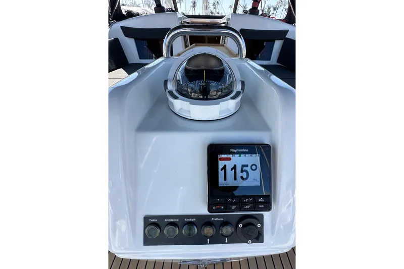 Best Day Ever Yacht Photos Pics Cockpit controls of 2022 Jeanneau Sun Odyssey 410 sailboat with compass and Raymarine display.