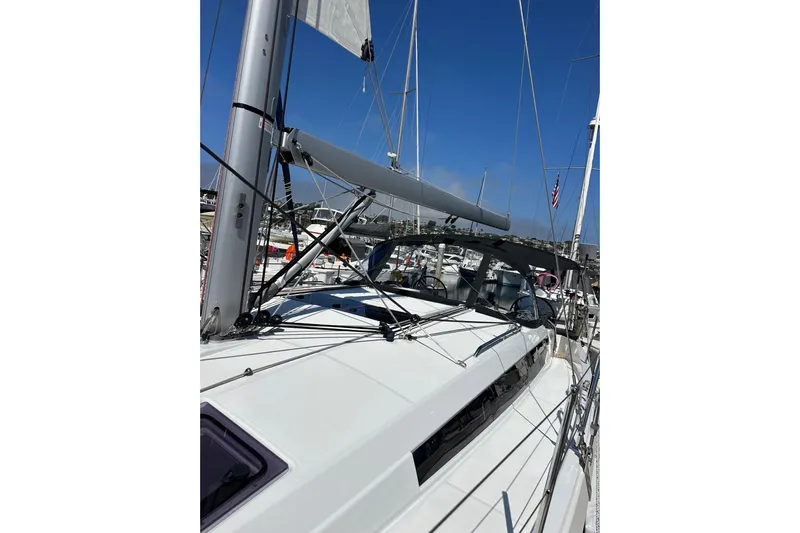 Best Day Ever Yacht Photos Pics 2022 Jeanneau Sun Odyssey 410 sailboat docked in a marina under clear blue skies.